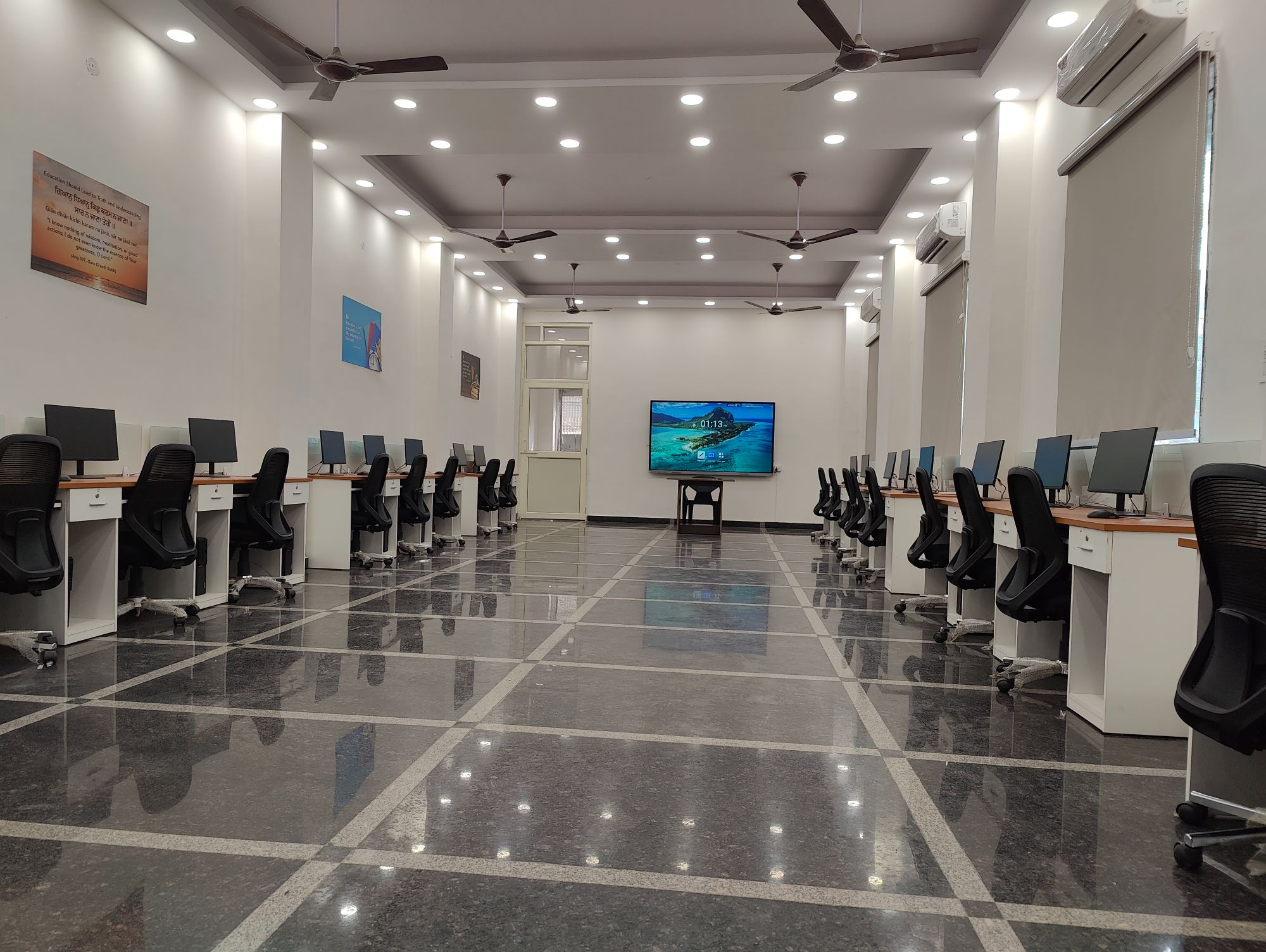 Students seated at computer workstations